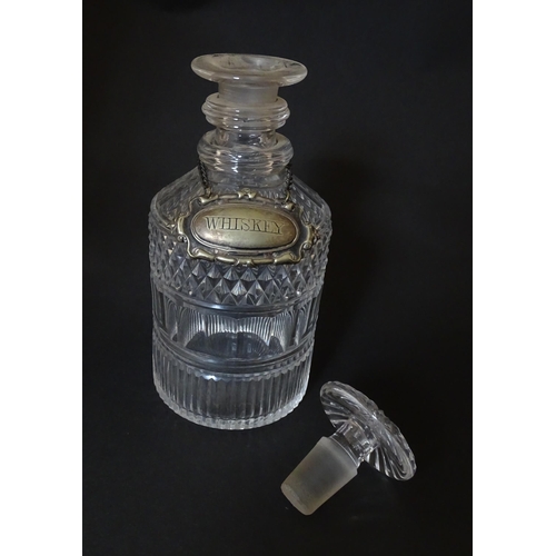 268 - A small 19thC three ring glass decanter with silver plate label. Approx. 7 1/2