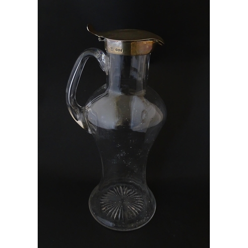 281 - A Victorian glass claret jug with loop handle and silver lid hallmarked London 1894, maker Hukin & H... 