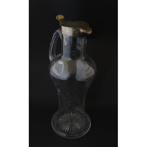 281 - A Victorian glass claret jug with loop handle and silver lid hallmarked London 1894, maker Hukin & H... 