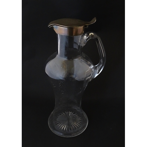 281 - A Victorian glass claret jug with loop handle and silver lid hallmarked London 1894, maker Hukin & H... 