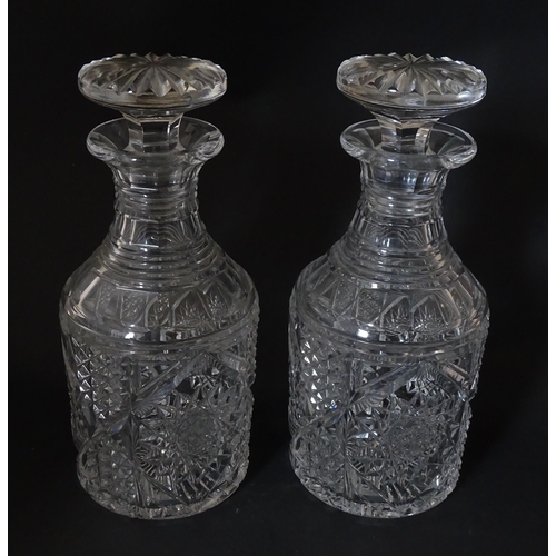 282 - A pair of cut glass / crystal decanters. Approx. 9 1/2