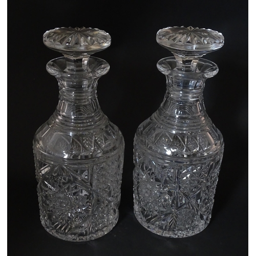 282 - A pair of cut glass / crystal decanters. Approx. 9 1/2