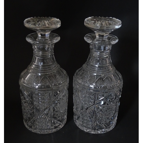 282 - A pair of cut glass / crystal decanters. Approx. 9 1/2