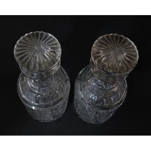 282 - A pair of cut glass / crystal decanters. Approx. 9 1/2