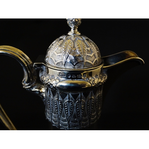 308 - A Victorian glass claret jug with etched floral, foliate and butterfly detail to body, having a silv... 