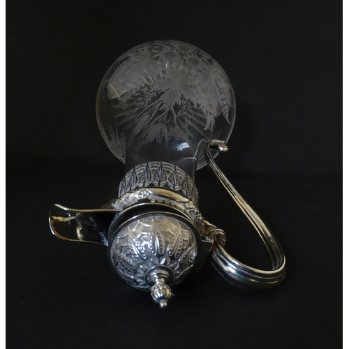 308 - A Victorian glass claret jug with etched floral, foliate and butterfly detail to body, having a silv... 