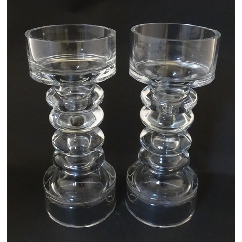 310 - A matched pair of glass candle holders of pillar form. In the Scandinavian style. Approx. 9 3/4