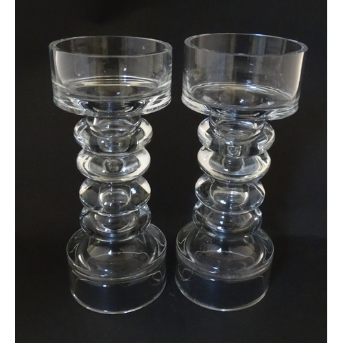 310 - A matched pair of glass candle holders of pillar form. In the Scandinavian style. Approx. 9 3/4