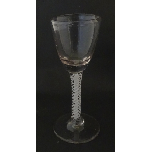 311 - A Georgian drinking glass with air twist stem. Approx. 5 1/4