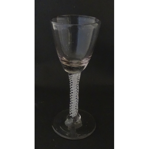 311 - A Georgian drinking glass with air twist stem. Approx. 5 1/4