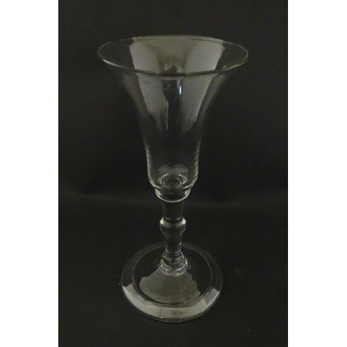 321 - A Georgian drinking glass with flared rim, folded foot and knop to stem. Approx. 6 1/4