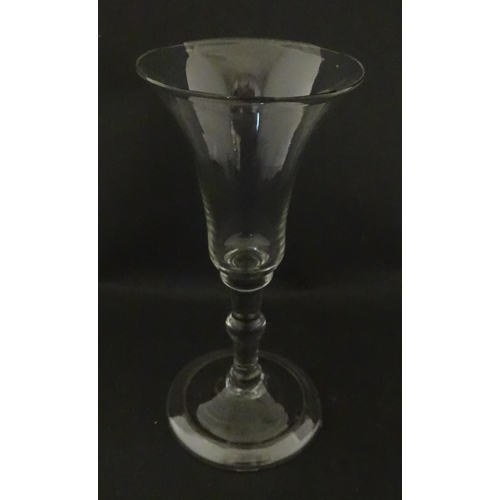 321 - A Georgian drinking glass with flared rim, folded foot and knop to stem. Approx. 6 1/4