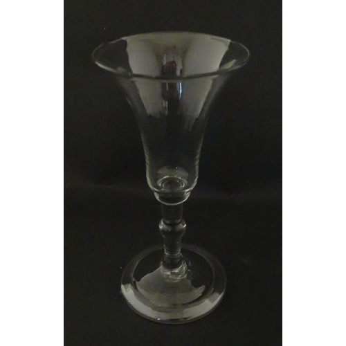 321 - A Georgian drinking glass with flared rim, folded foot and knop to stem. Approx. 6 1/4