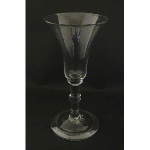 321 - A Georgian drinking glass with flared rim, folded foot and knop to stem. Approx. 6 1/4