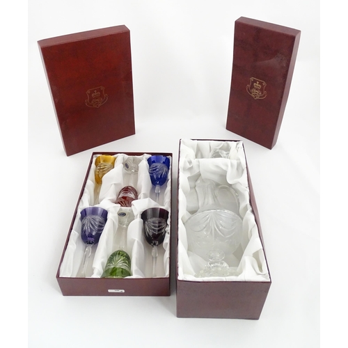 338 - A boxed set of six coloured wine glasses / hock glasses, each with hobnail and swag decoration, sign... 