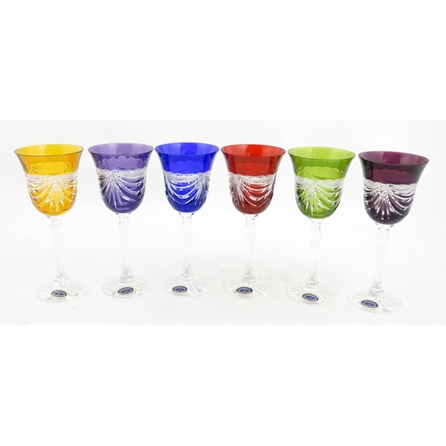 338 - A boxed set of six coloured wine glasses / hock glasses, each with hobnail and swag decoration, sign... 