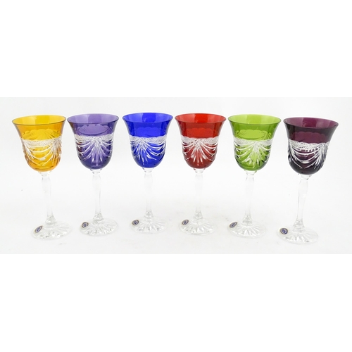 338 - A boxed set of six coloured wine glasses / hock glasses, each with hobnail and swag decoration, sign... 