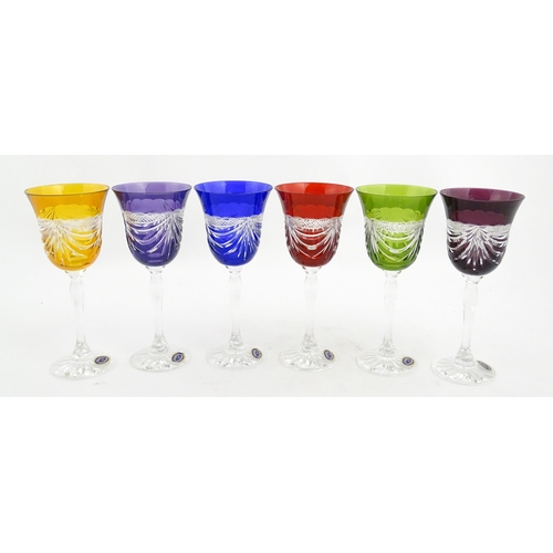 338 - A boxed set of six coloured wine glasses / hock glasses, each with hobnail and swag decoration, sign... 