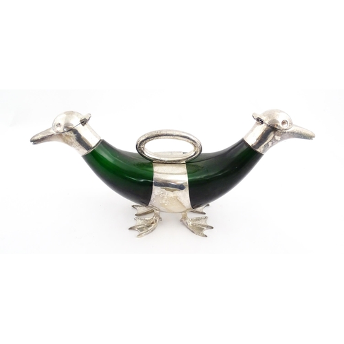 343 - A late 20thC novelty decanter / claret jug formed as a twin headed duck, the green glass body with s... 