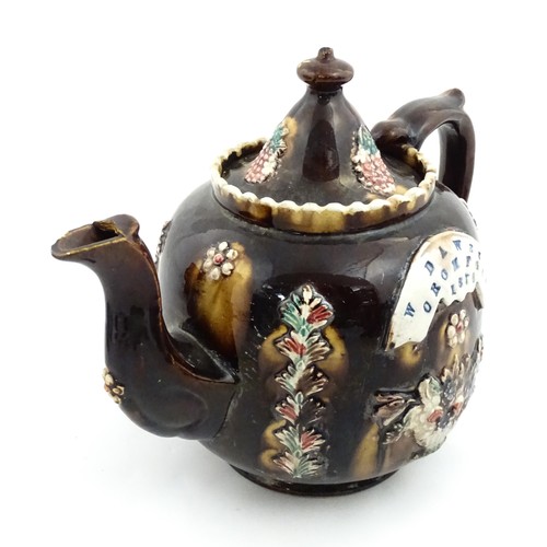 218 - A Victorian Measham bargeware Toby / Character teapot bearing a plaque titled W Dawes Cromford 1878,... 