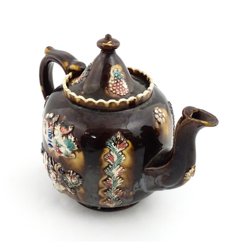 218 - A Victorian Measham bargeware Toby / Character teapot bearing a plaque titled W Dawes Cromford 1878,... 