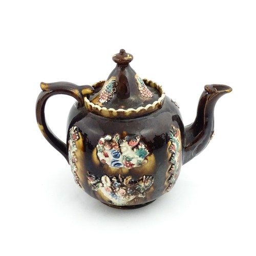 218 - A Victorian Measham bargeware Toby / Character teapot bearing a plaque titled W Dawes Cromford 1878,... 