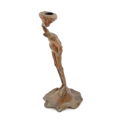 1201 - An Art Nouveau cast novelty candlestick modelled as a stylised standing frog on a lily pad holding a... 