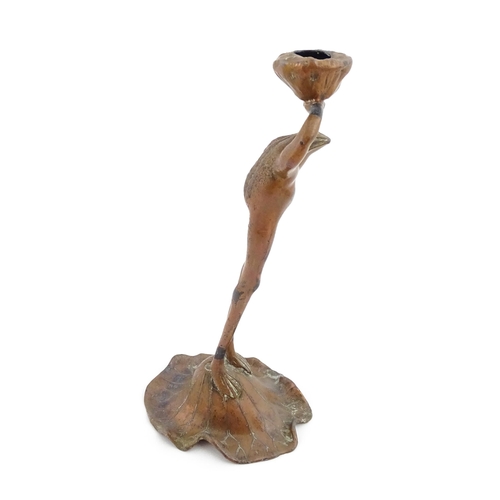 1201 - An Art Nouveau cast novelty candlestick modelled as a stylised standing frog on a lily pad holding a... 