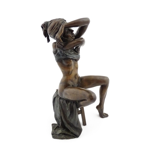 1206 - A bronze sculpture by Benson Landes (1927-2013) depicting a seated lady undressing on a stool. Signe... 