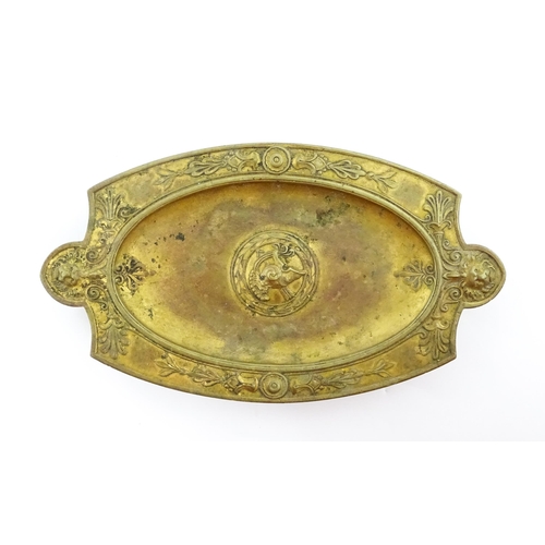 1210 - A 19thC French gilt brass dish / stand of shaped form raised on four lion paw feet, decorated with l... 