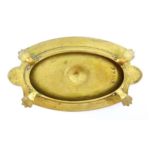 1210 - A 19thC French gilt brass dish / stand of shaped form raised on four lion paw feet, decorated with l... 