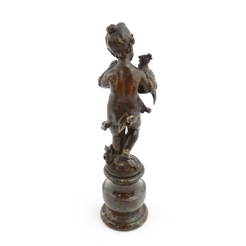 1211 - A late 19th / early 20thC bronze sculpture modelled as a young girl holding a cockatoo bird, raised ... 