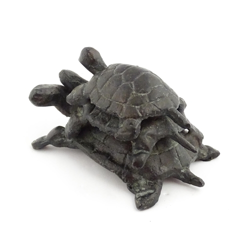 1215 - A 20thC cast sculpture, Travelling Turtles, modelled as three turtles. Approx. 3