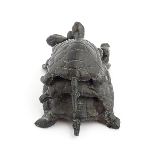 1215 - A 20thC cast sculpture, Travelling Turtles, modelled as three turtles. Approx. 3