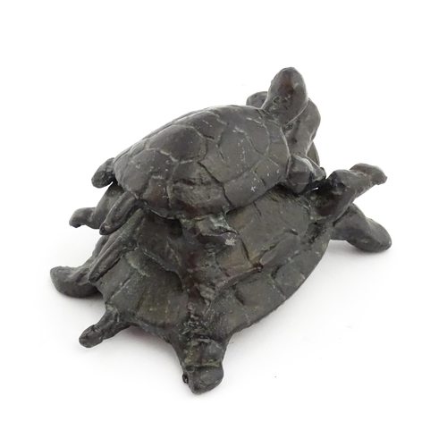 1215 - A 20thC cast sculpture, Travelling Turtles, modelled as three turtles. Approx. 3