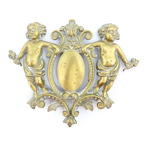 1218 - A late 19th / early 20thC cast brass plaque / mount formed as a cartouche flanked by two cherubs / p... 