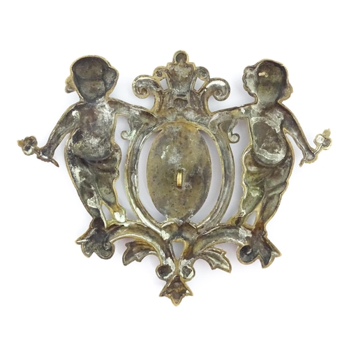 1218 - A late 19th / early 20thC cast brass plaque / mount formed as a cartouche flanked by two cherubs / p... 