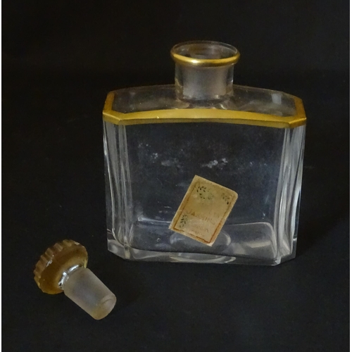 1224 - An early 20thC French glass perfume flask / scent bottle with gilt highlights, with gilt metal trave... 