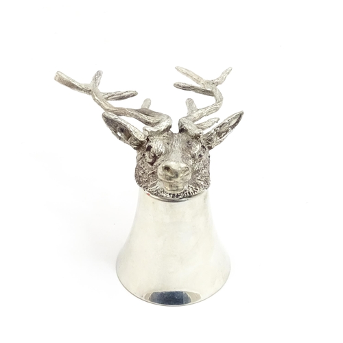 1312 - A 20thC novelty stirrup cup of tapering form modelled as a stag head with antler supports. Approx. 3... 