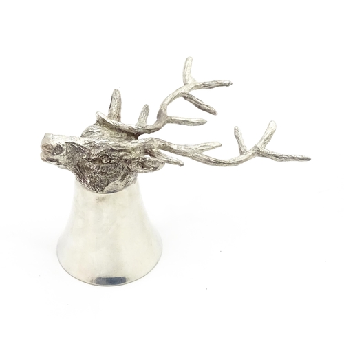 1312 - A 20thC novelty stirrup cup of tapering form modelled as a stag head with antler supports. Approx. 3... 