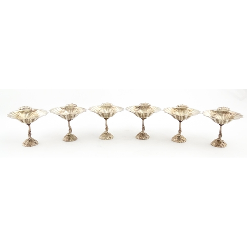 1314 - A set of six 20thC silver plate bon bon dishes with scallop shell bowls raised on dolphin / fish sup... 