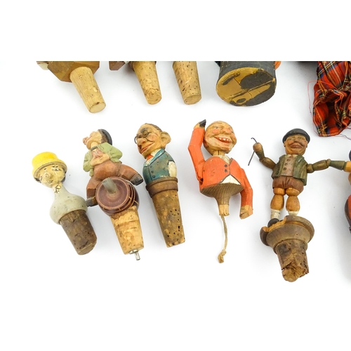 1316 - A quantity of 20thC Continental carved and composite novelty bottle stoppers to include figures and ... 