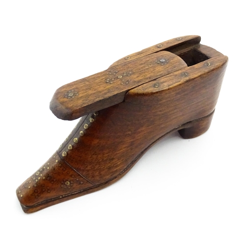 1357 - Treen : A 19thC shoe snuff box with sliding lid and inlaid brass studwork decoration. Approx. 3 3/4