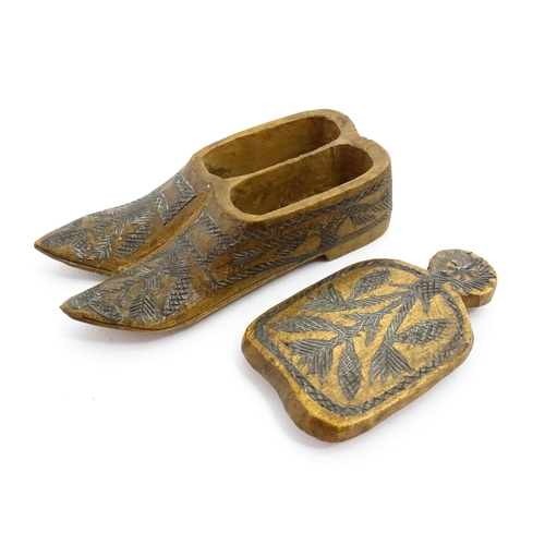 1360 - Treen : A 19thC Continental double shoe snuff box modelled as a pair of shoes with crosshatched foli... 