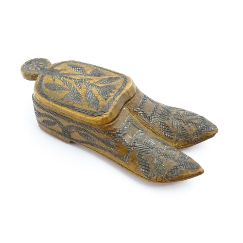 1360 - Treen : A 19thC Continental double shoe snuff box modelled as a pair of shoes with crosshatched foli... 