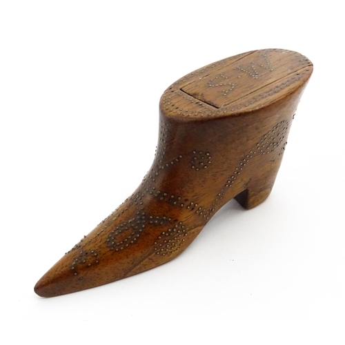 1368 - Treen : A 19thC shoe snuff box of boot form with inlaid brass studwork decoration, the sliding lid w... 