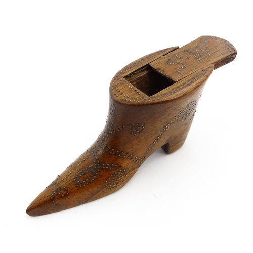 1368 - Treen : A 19thC shoe snuff box of boot form with inlaid brass studwork decoration, the sliding lid w... 