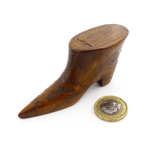 1368 - Treen : A 19thC shoe snuff box of boot form with inlaid brass studwork decoration, the sliding lid w... 