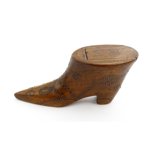 1368 - Treen : A 19thC shoe snuff box of boot form with inlaid brass studwork decoration, the sliding lid w... 