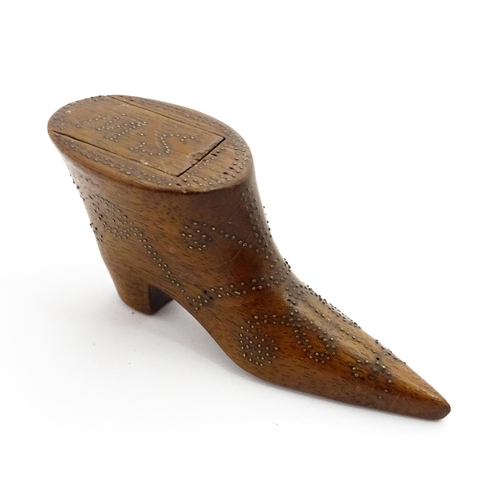 1368 - Treen : A 19thC shoe snuff box of boot form with inlaid brass studwork decoration, the sliding lid w... 